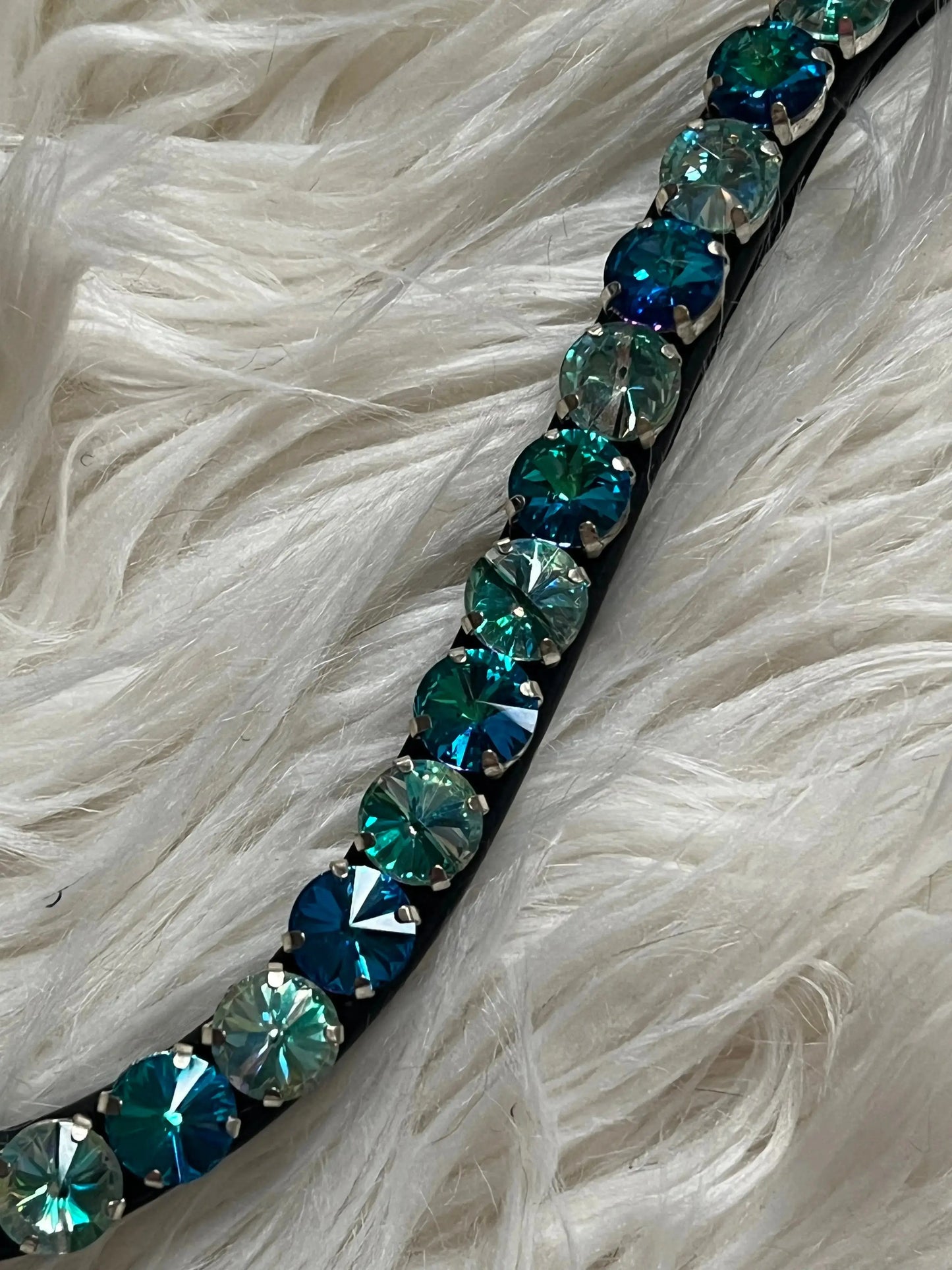 Blau-grüner Stirnriemen 12mm Rivoli mit Quick-Change Verschluss auf weißem Fell